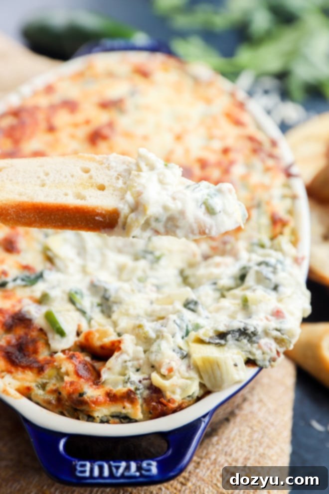 Kickin' Bacon Artichoke Dip 2 Bacon Jalapeño Spinach Artichoke Dip, fresh out of the oven, golden and bubbly.