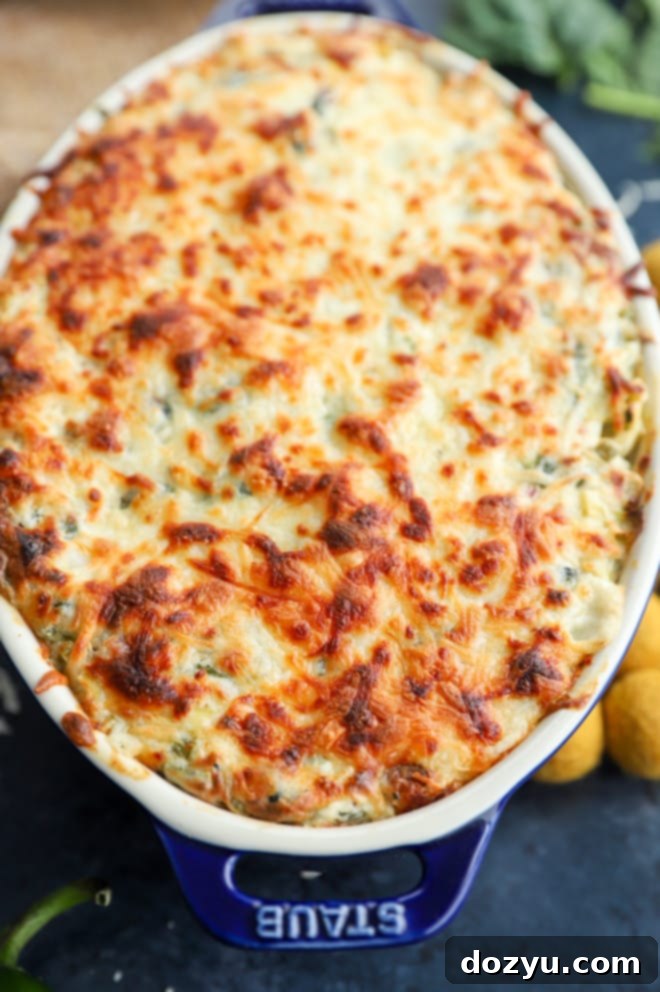 Kickin' Bacon Artichoke Dip 8 Picture of baking jalapeño artichoke dip, bubbling and golden in the oven.