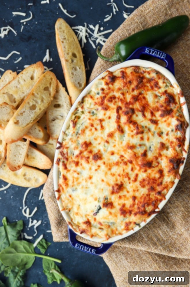 Kickin' Bacon Artichoke Dip 4 Overhead image of spinach artichoke dip in dish, ready to be served.