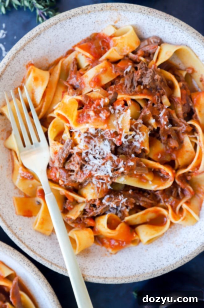 Instant Pot Short Rib Ragu garnished with fresh parsley and Parmesan cheese