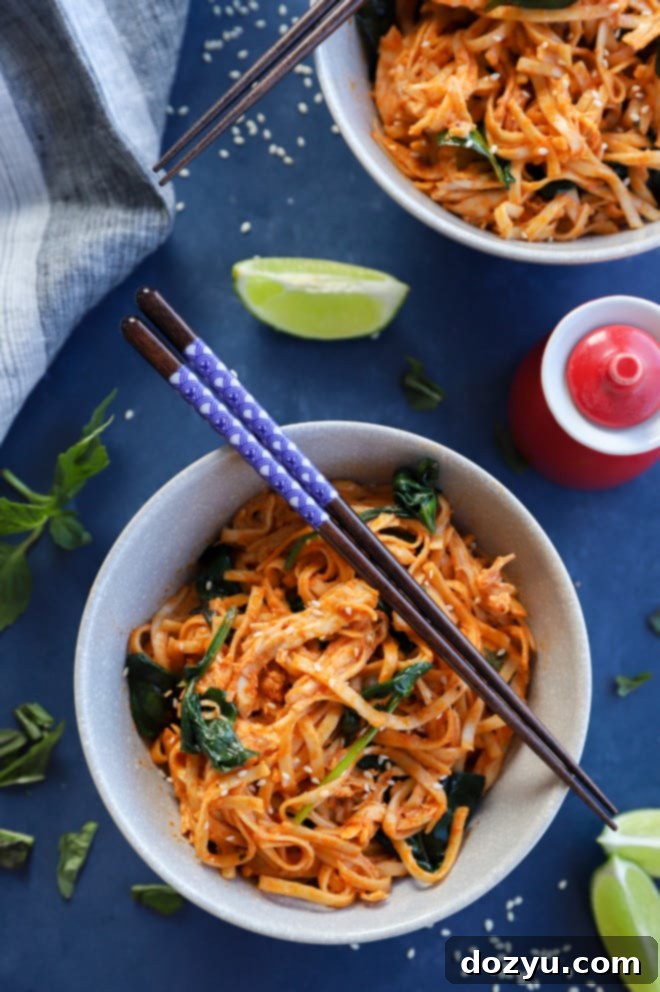 Easy weeknight noodle dish Korean inspired photo with vibrant Gochujang Noodles, chicken, and spinach