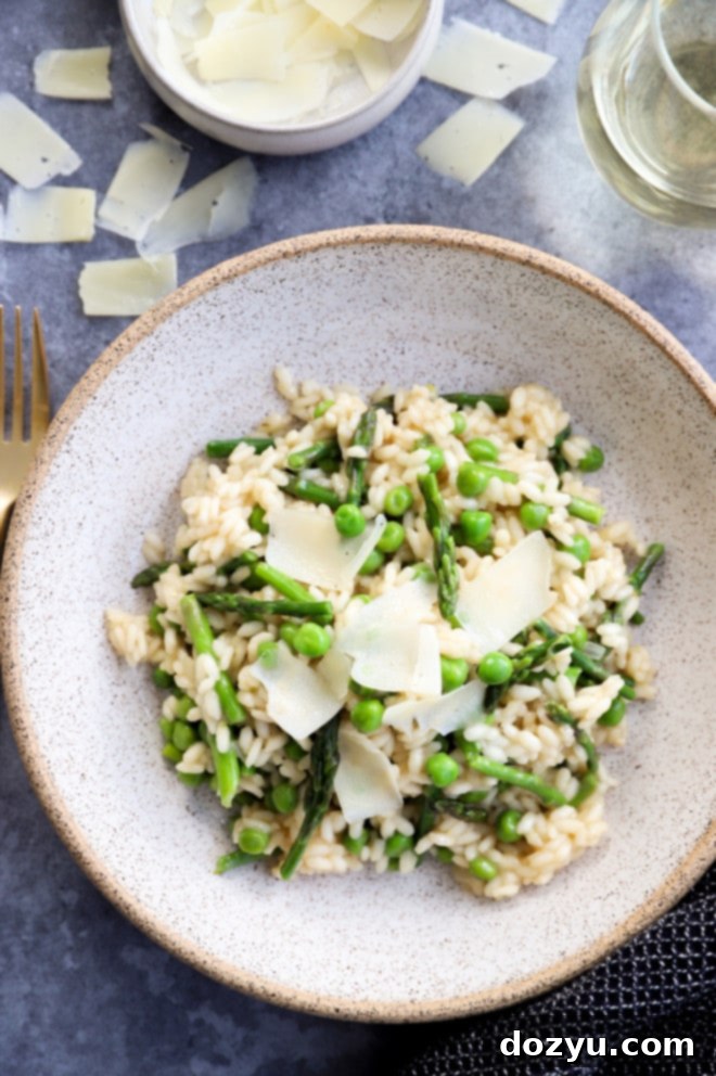 Overhead view of a beautiful bowl of spring risotto with asparagus and peas, garnished and ready to serve.