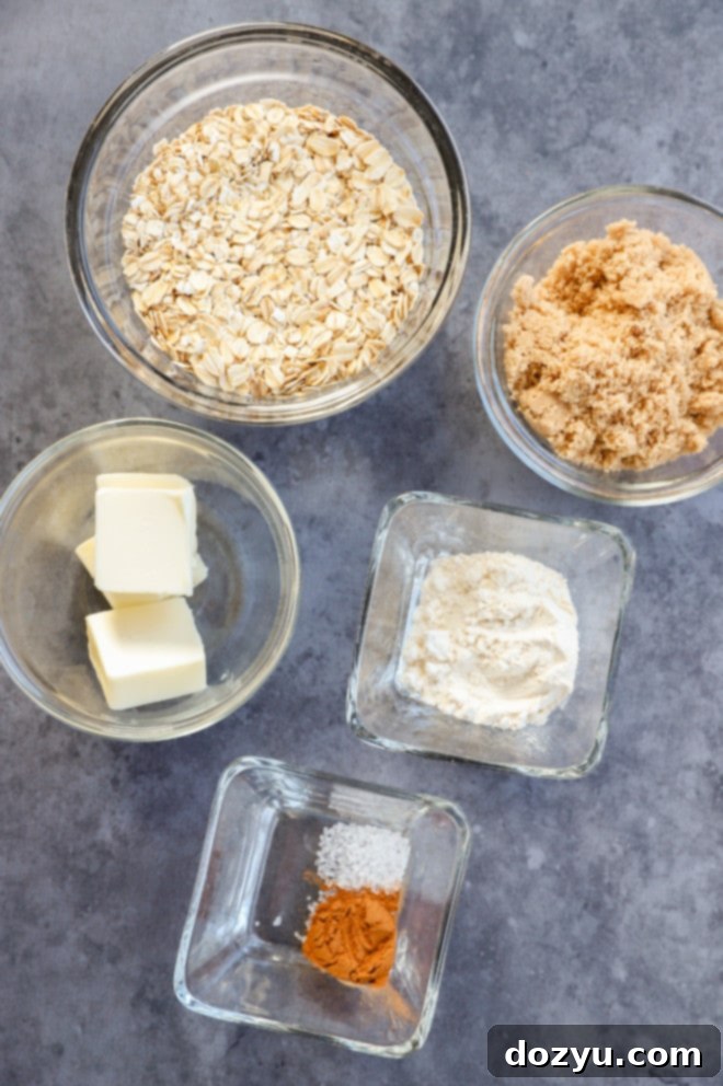 Image displaying dry and wet ingredients for the crumble topping, including oats, flour, sugar, and butter