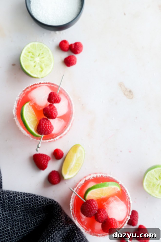 Overhead image of raspberry margaritas in glasses