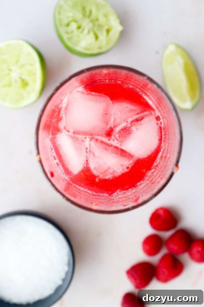 Overhead image of raspberry margarita being made in cocktail shaker