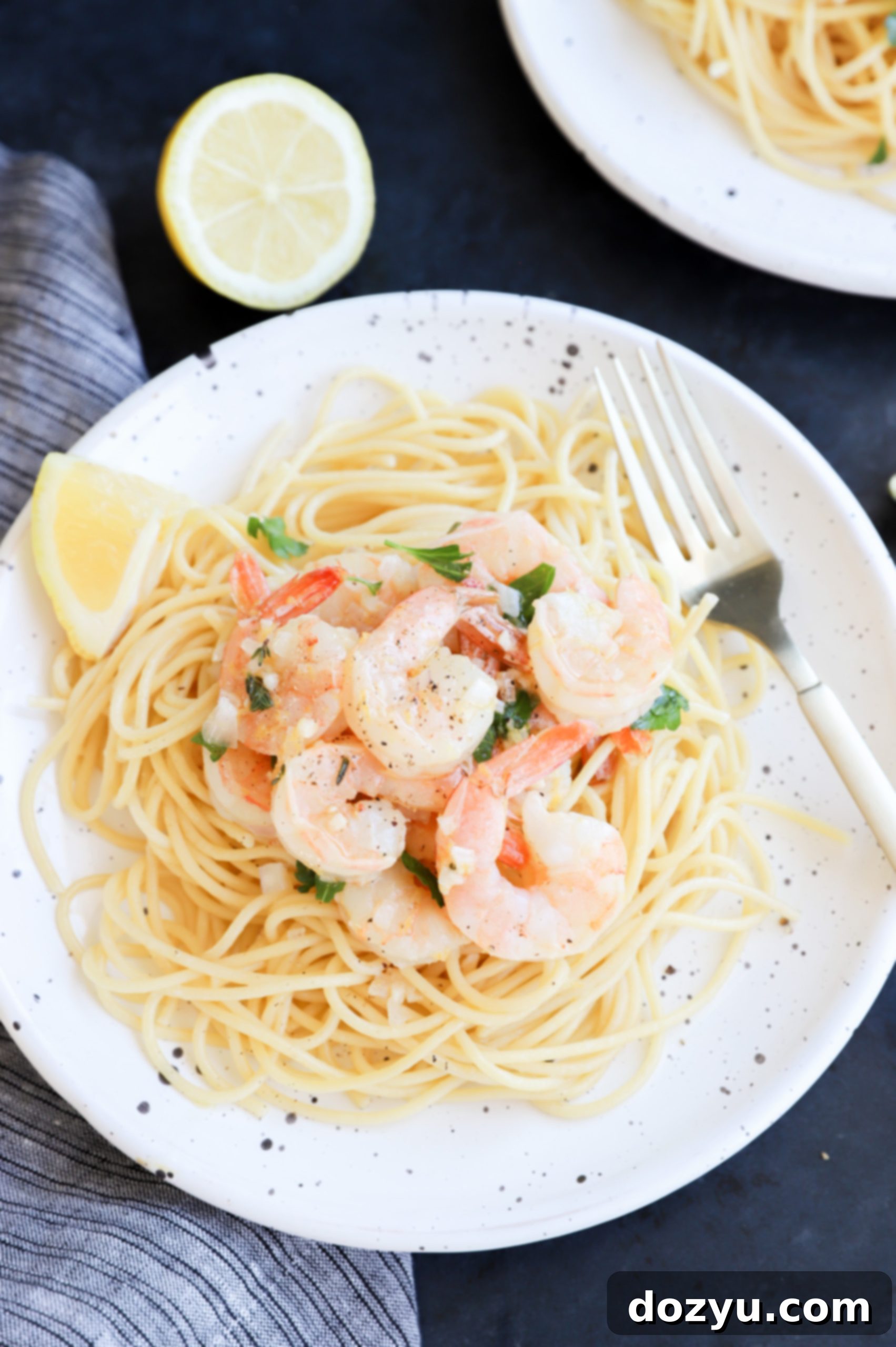 Roasted shrimp served over lemon garlic pasta with fresh herbs