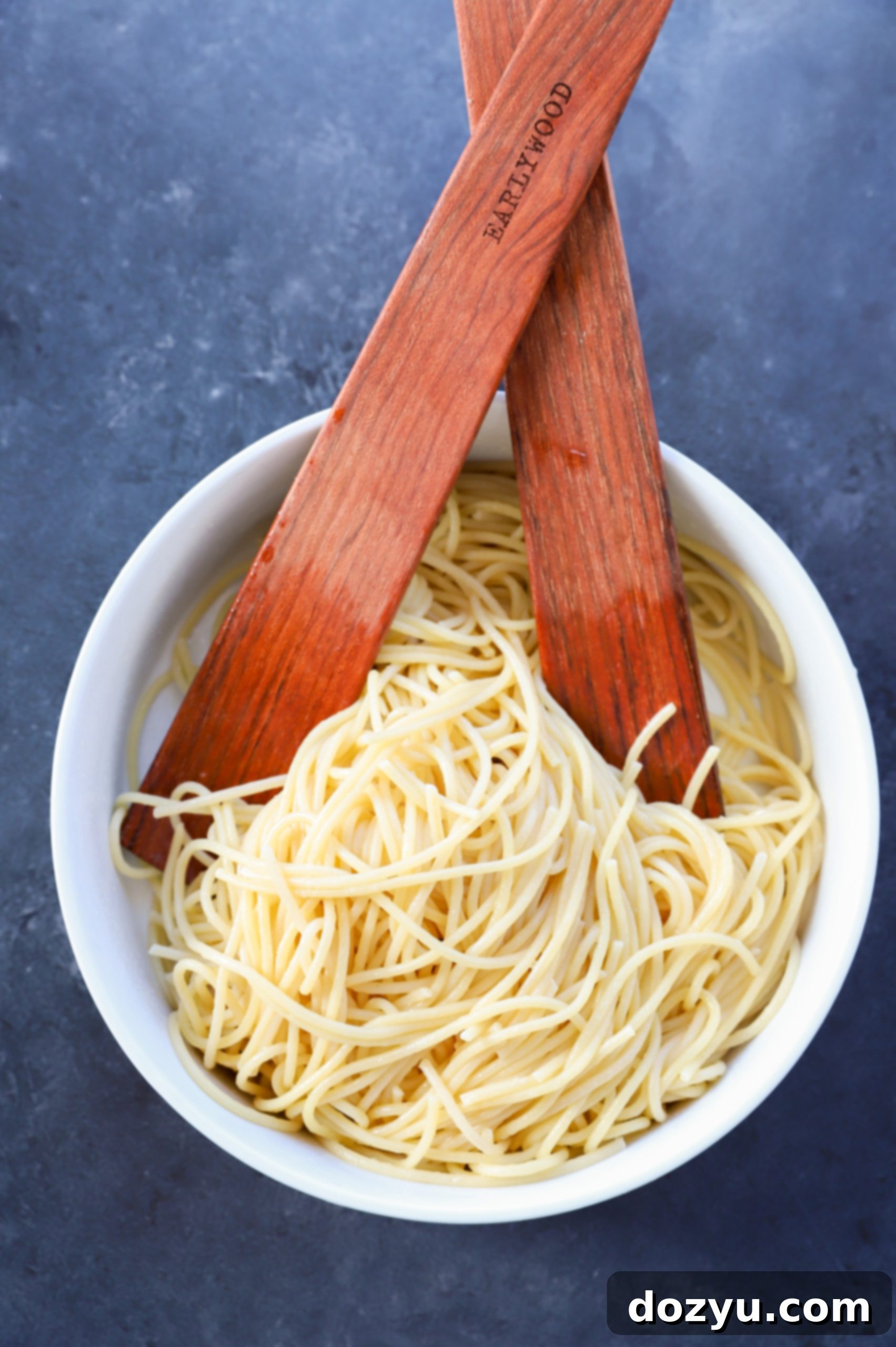 Cooked spaghetti in a bowl with melted butter