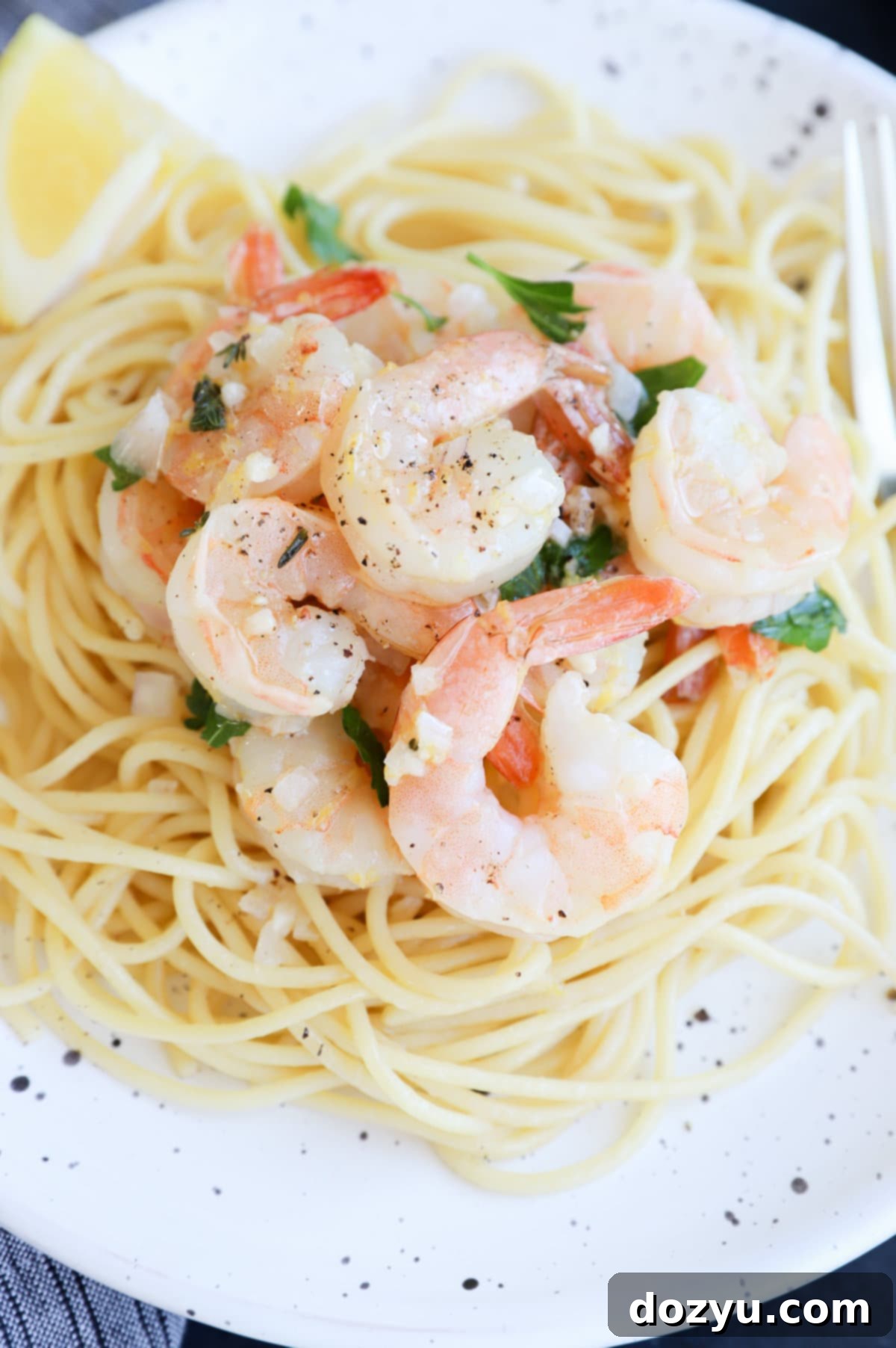 Roasted Lemon Garlic Shrimp Pasta served in a bowl with fresh lemon and parsley