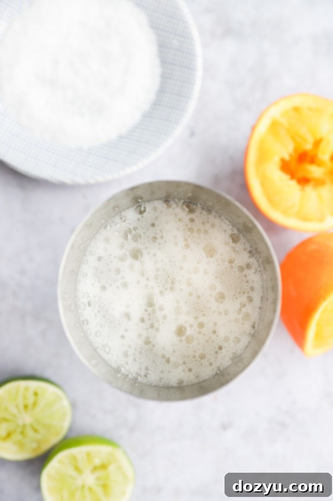 A cocktail shaker filled with ice, ready to mix a Texas Margarita.
