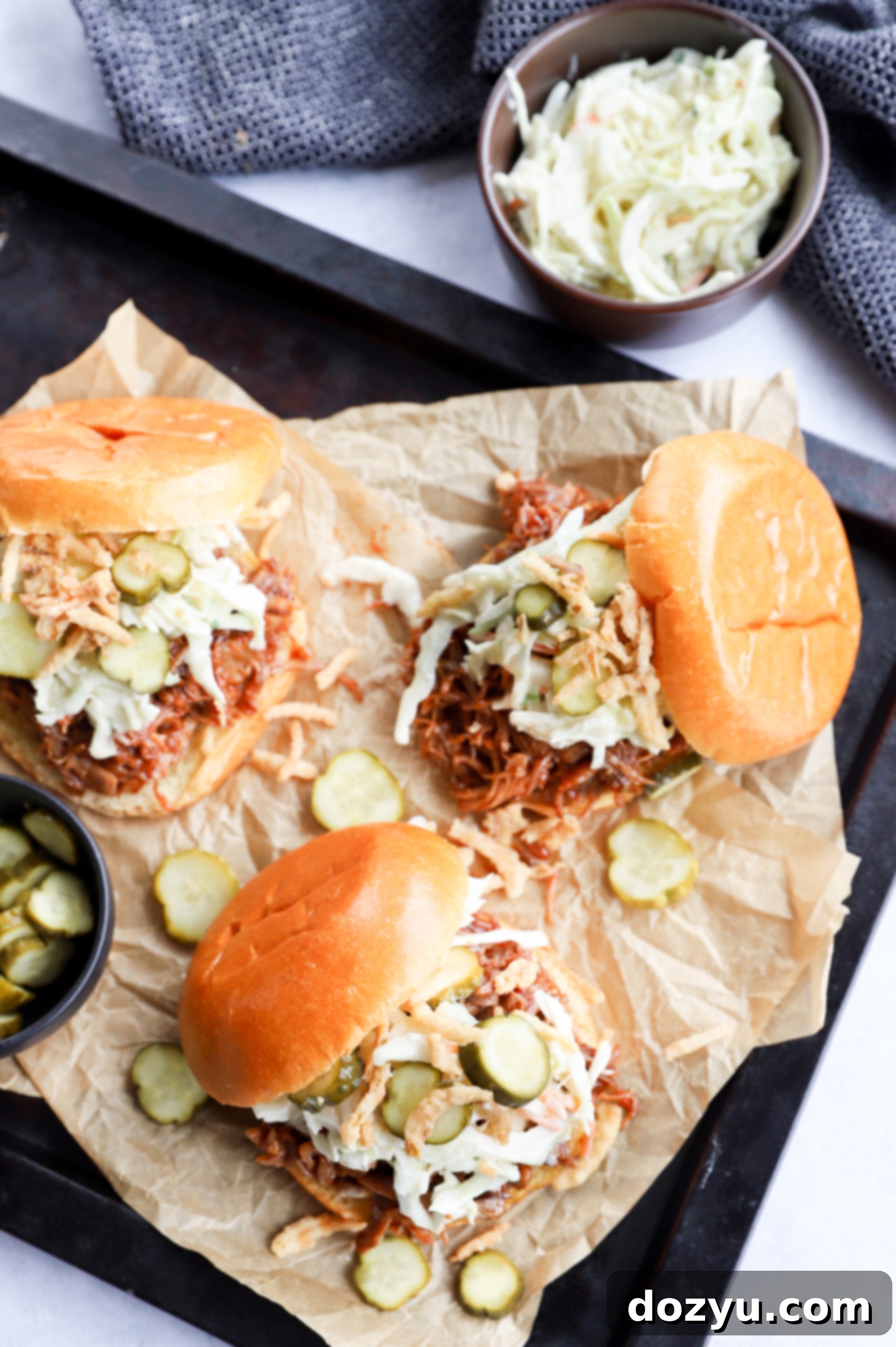 Overhead image of pulled pork burgers on pan