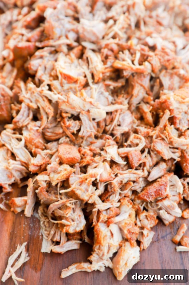 Cooked shredded pork on cutting board image