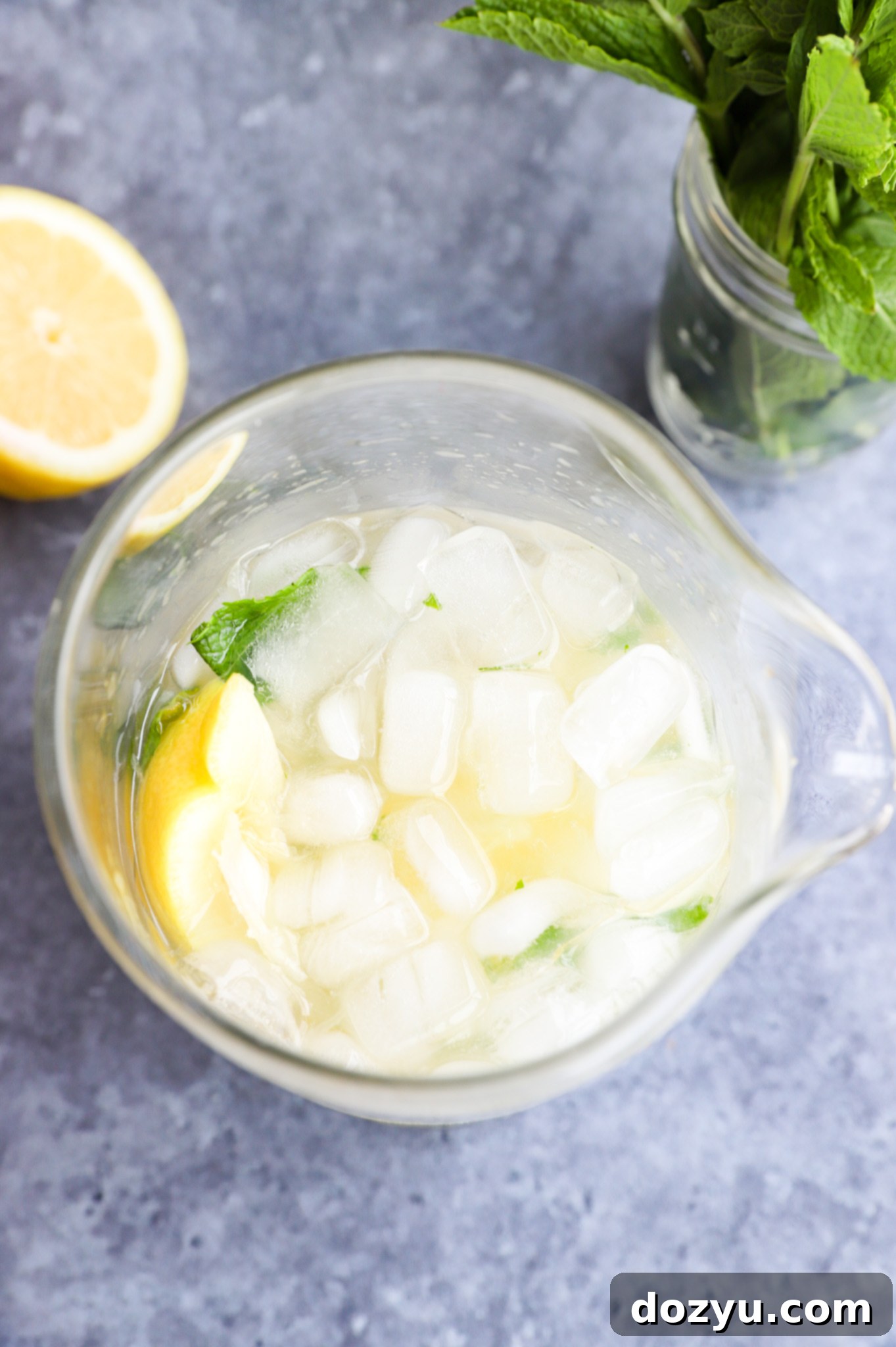 Making a citrus mint cocktail in a mixing glass photo