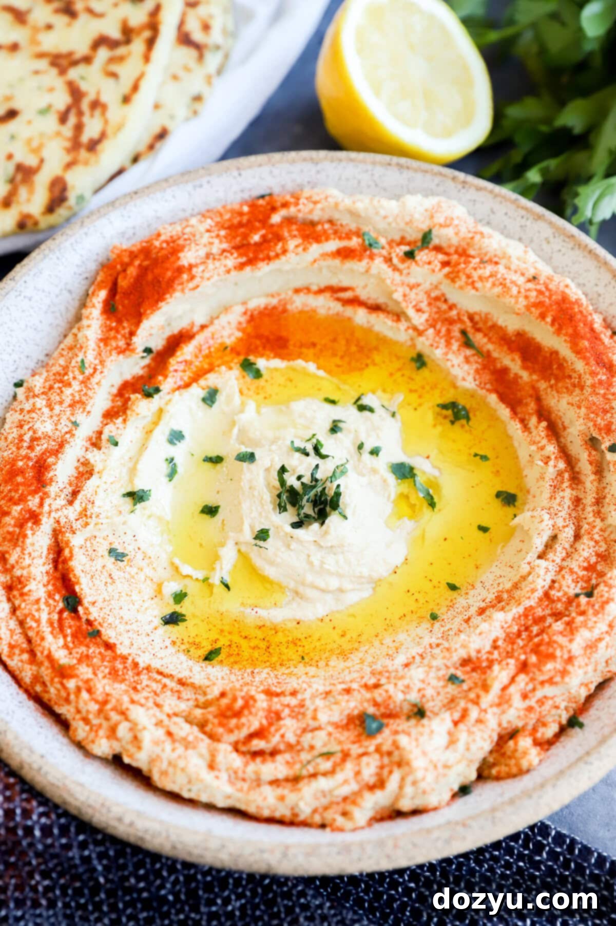 authentic chickpea creamy dip in a bowl with olive oil and sumac garnish