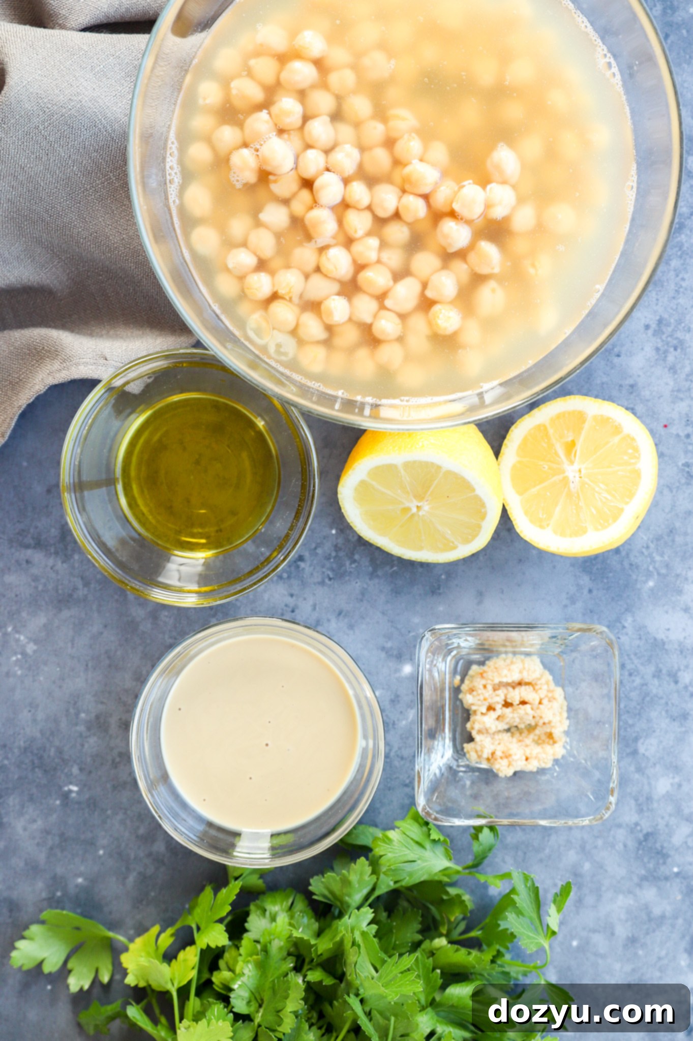 Ingredients of Greek hummus recipe laid out on a kitchen surface