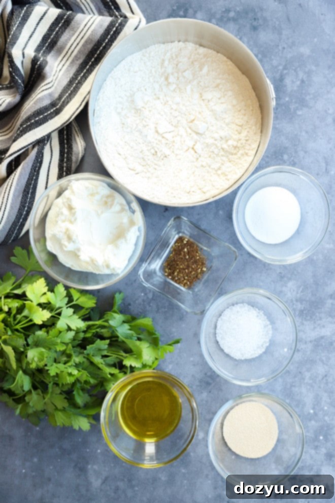 Assortment of fresh ingredients laid out for preparing Turkish bread, including flour, yogurt, olive oil, yeast, sugar, salt, parsley, and za'atar.