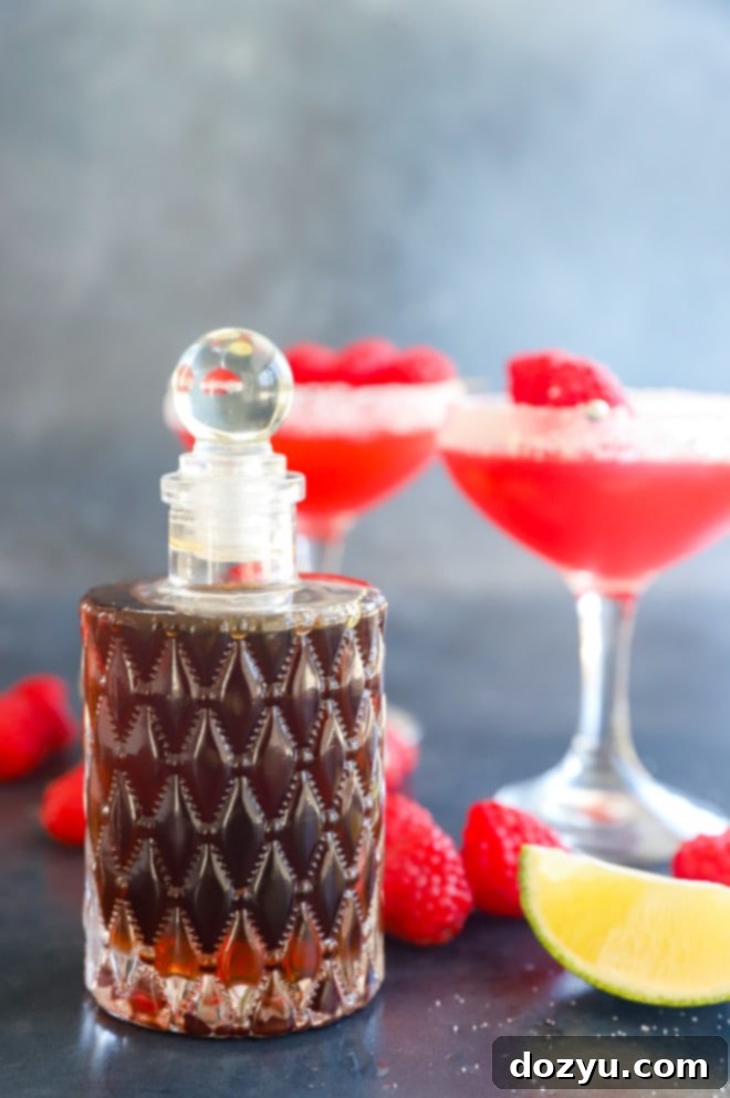 A glass bottle filled with golden demerara syrup, ready for use in cocktails and drinks.