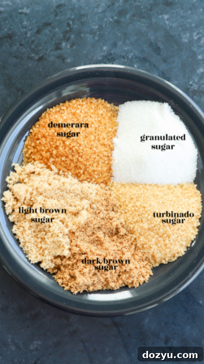 Photo of a variety of sugar types on a plate, highlighting the difference in color and texture of demerara sugar compared to others.