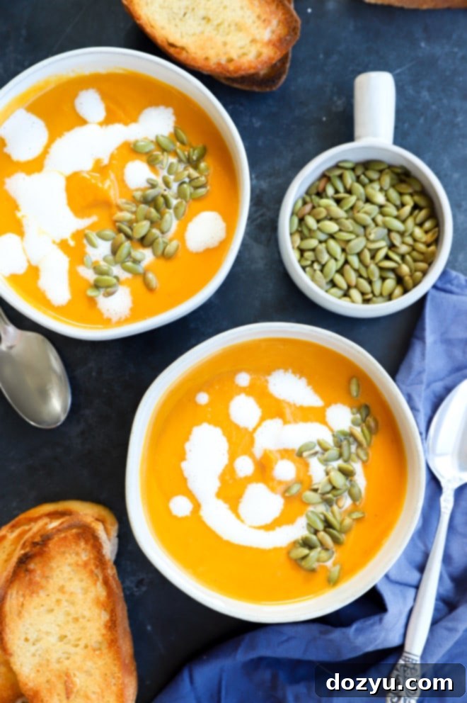 Image of pumpkin sweet potato soup in rustic bowls, garnished with seeds and cream