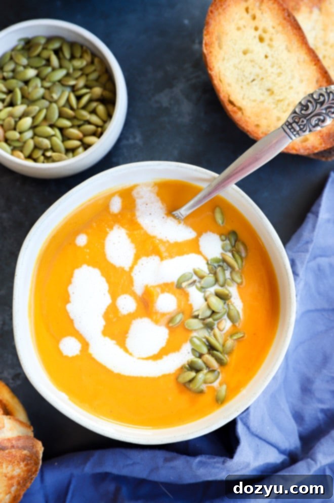 Picture of cozy fall soup in bowl with crusty bread and roasted seeds