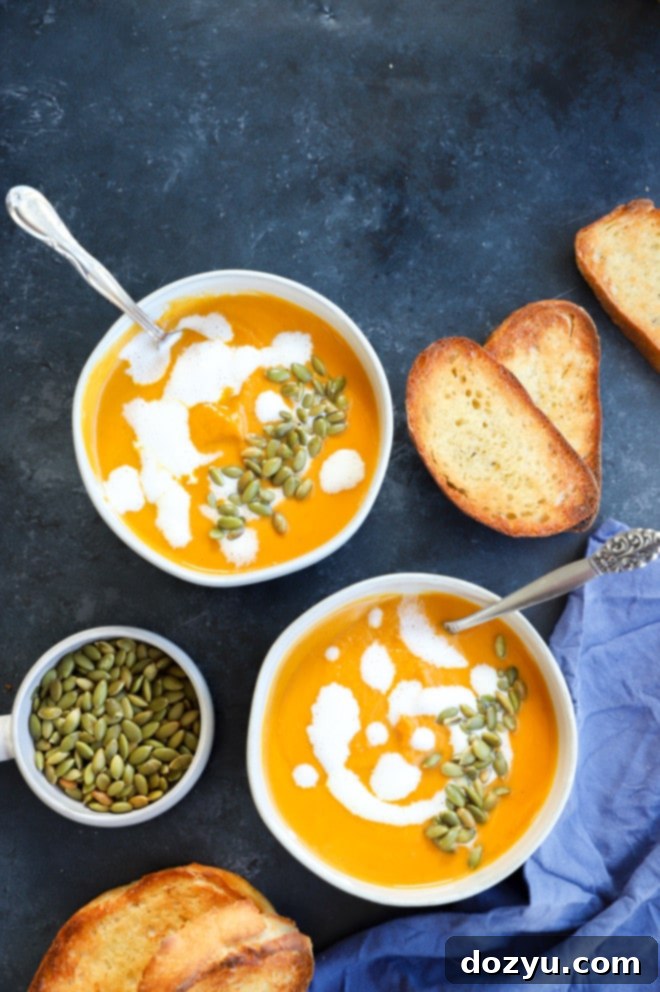 Image of bowls of fall dinner with roasted pumpkin seeds and heavy cream on top