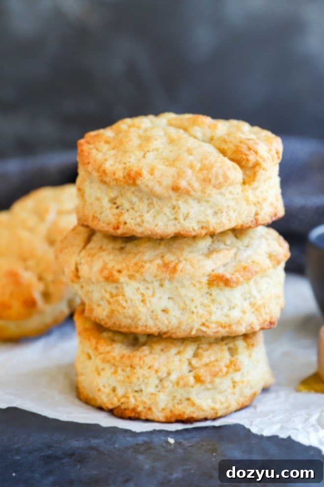 A stack of perfectly baked, buttery bread on parchment paper, ready to be enjoyed.