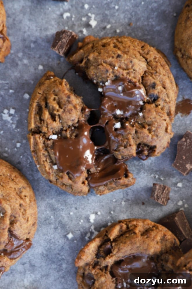 Pulling apart a gooey chocolate cookie with salt and espresso