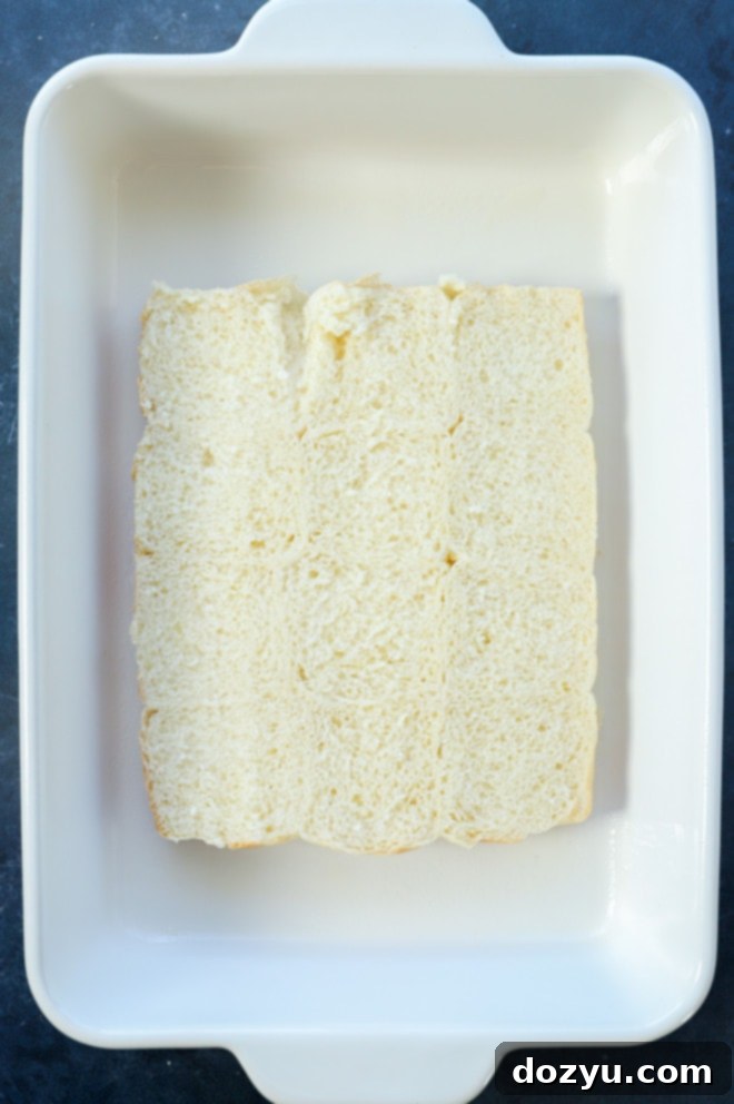 bottom half of Hawaiian rolls neatly arranged in a baking dish