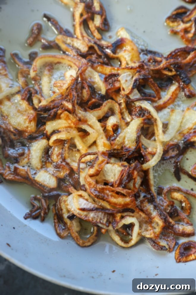close up of perfectly golden brown caramelized onions in a skillet