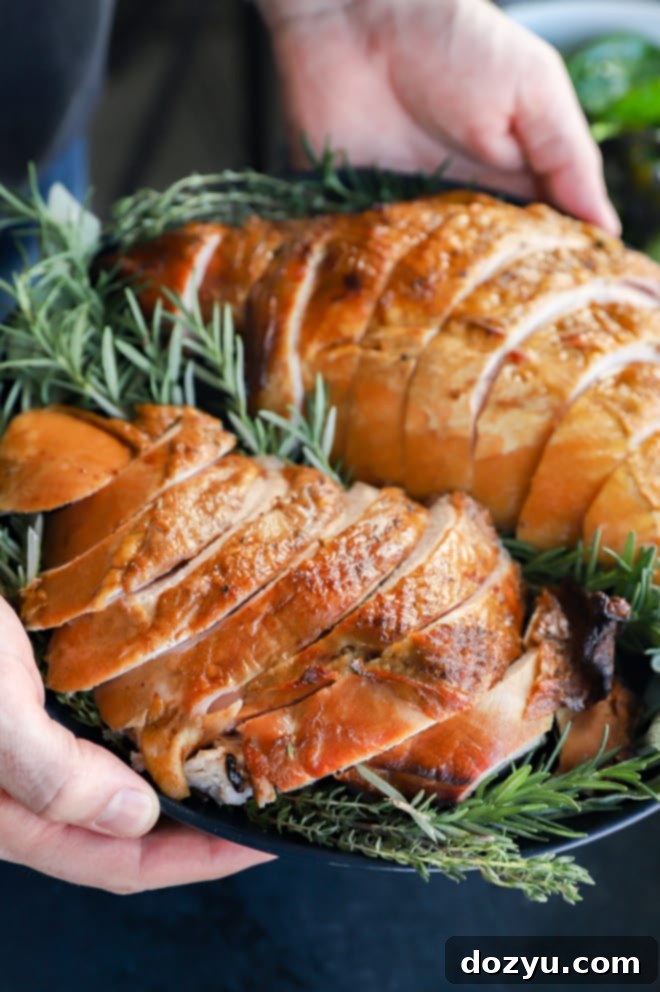 Signature Smoked Turkey Breast 2 Hands holding a plate of sliced meat for a holiday meal