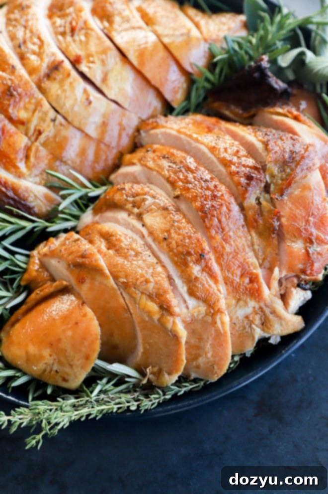 Signature Smoked Turkey Breast 7 Plate of sliced smoked turkey breast with herbs