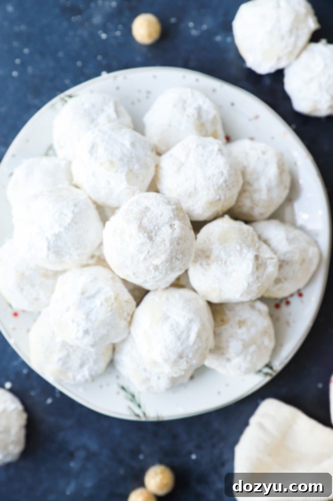 Plate of Mexican wedding cookies on a tray, covered in powdered sugar