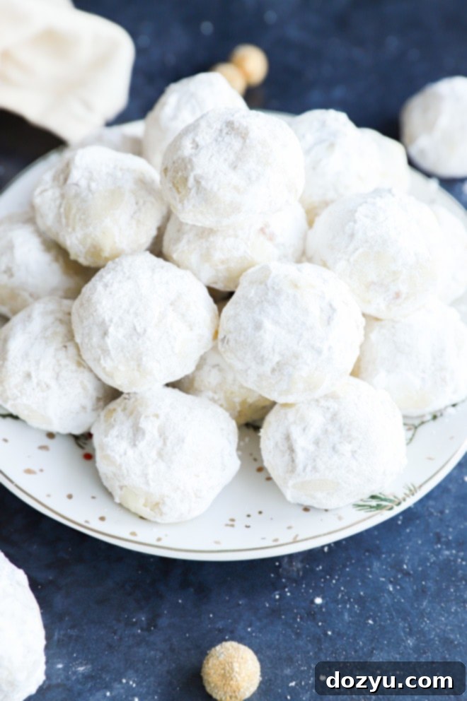 A plate overflowing with a delicious pile of snowball cookies