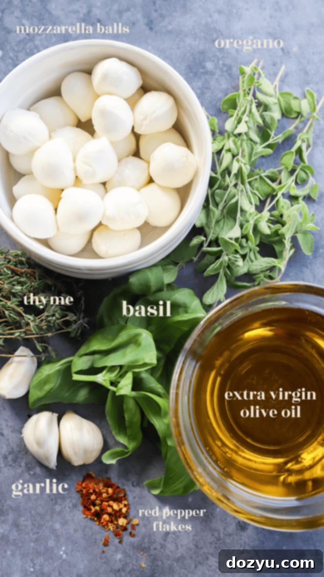 Close-up of fresh ingredients for marinated mozzarella balls, including olive oil, garlic, and herbs
