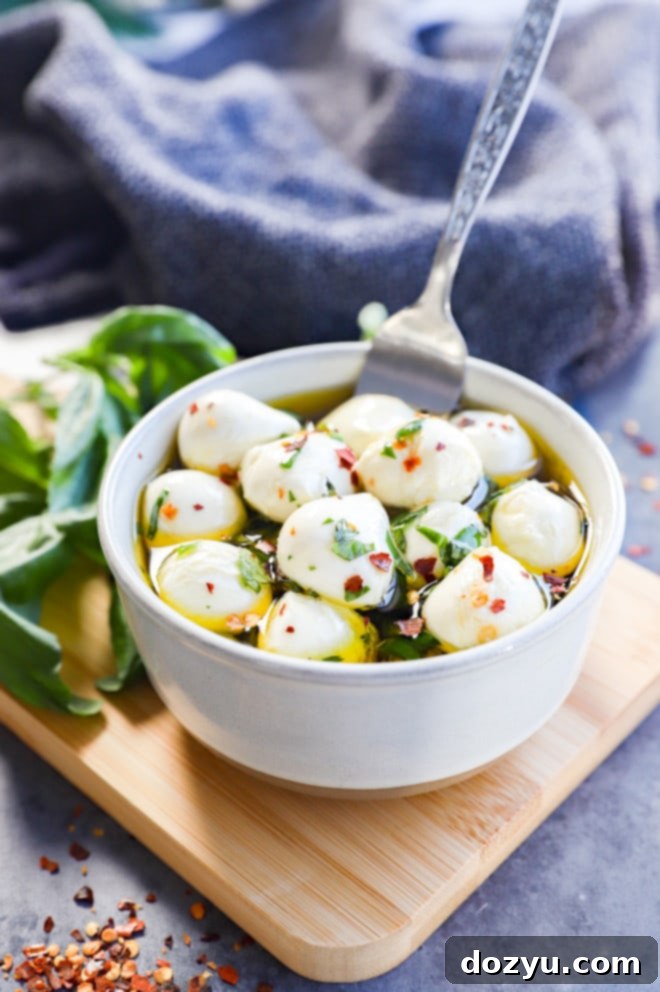 Easy Italian appetizer with marinated cheese and fresh herbs, perfect for a party