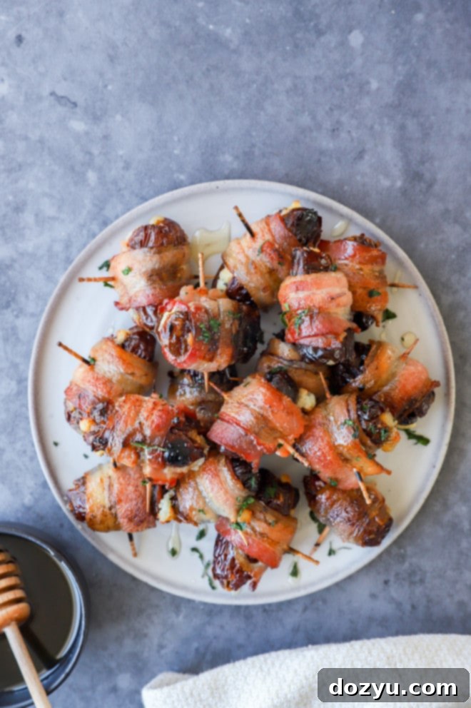 Plate of bacon wrapped dates stuffed with goat cheese and drizzled with honey
