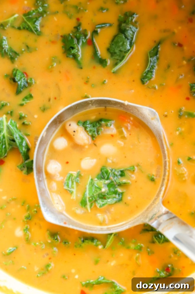 Tuscan Cannellini Bean Soup 6 Ladling out Tuscan white bean soup from a large pot into a bowl