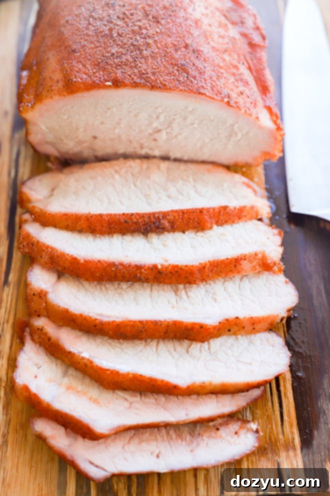 Sliced pork loin on a cutting board with knife