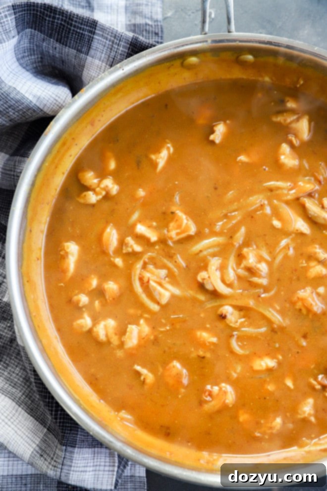 Hearty Golden Curry Udon 4 Making curry udon noodle sauce in a skillet