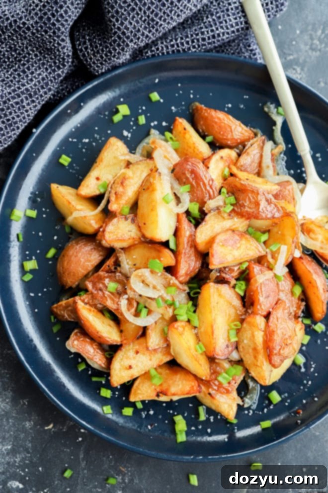 Golden Oven-Fried Potatoes and Onions 5 Chives on top of fried potatoes and onions made in the oven