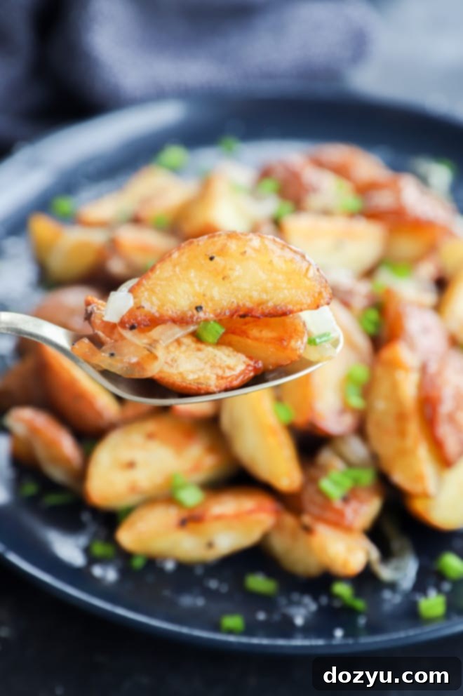 Golden Oven-Fried Potatoes and Onions 7 Spoonful of side dish with chives and salt