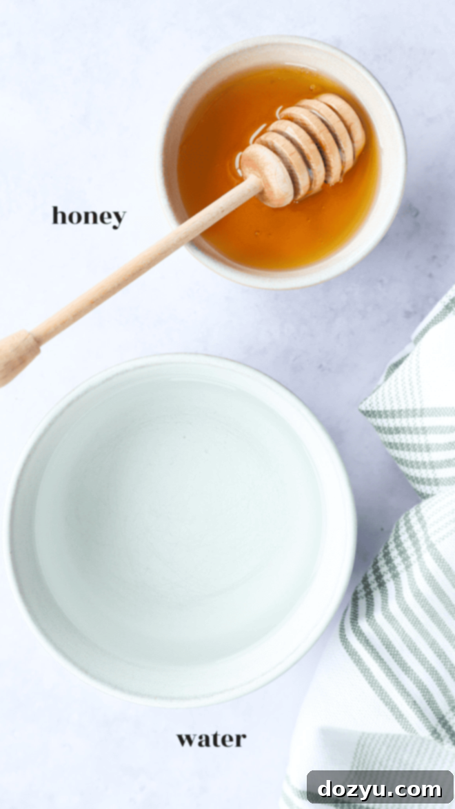 honey simple syrup ingredients image with text labels, clearly showing honey and water