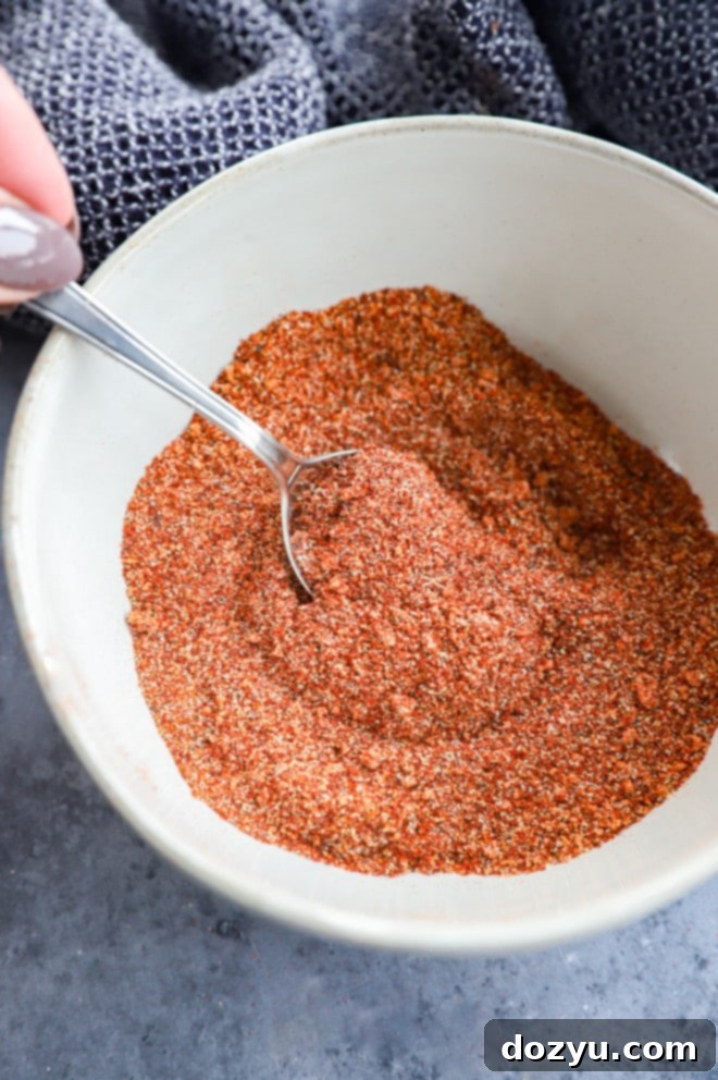 stirring together bbq chicken rub in bowl