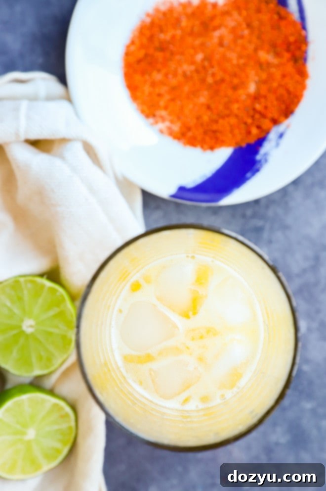 Preparing a passion fruit margarita in a cocktail shaker, showing the mixing process.