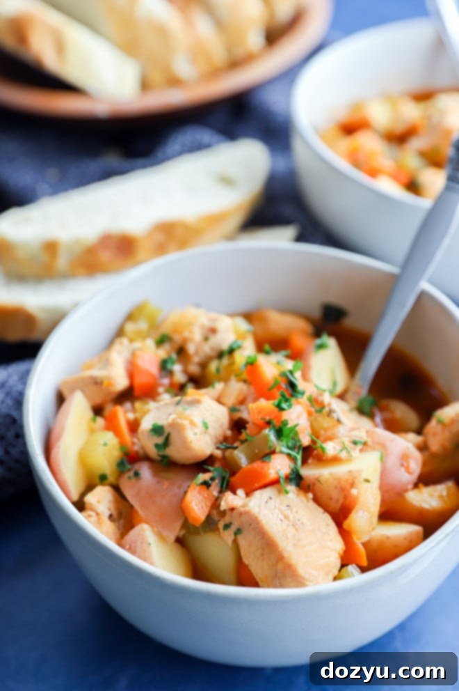 Hearty Instant Pot Chicken Stew 7 chicken soup in a bowl with fresh herbs and crusty bread