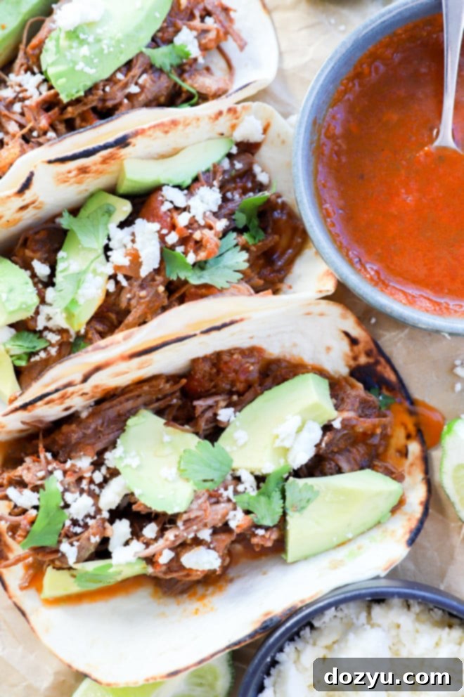 overhead image of shredded beef tacos and toppings