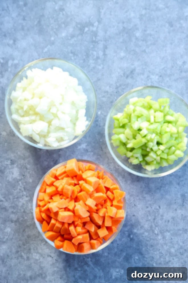 Effortless Mirepoix 2 Ingredients for a classic mirepoix recipe: diced onions, carrots, and celery ready for cooking.