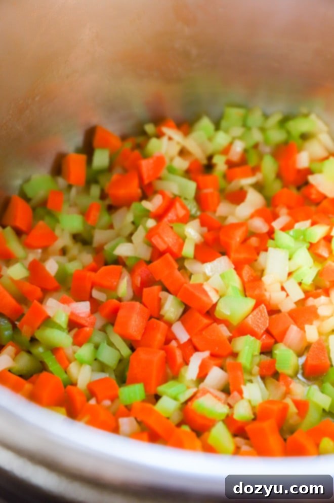Effortless Mirepoix 6 A colorful array of chopped onions, carrots, and celery in separate bowls, ready for a mirepoix recipe preparation.