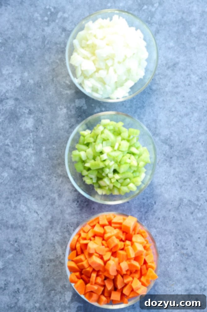Effortless Mirepoix 7 Bowls of perfectly chopped onions, celery, and carrots, separated and ready to be combined for a mirepoix.