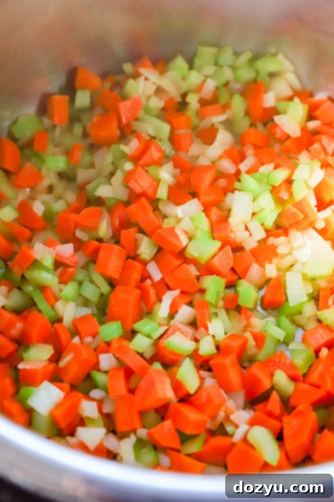 Effortless Mirepoix 8 Sautéing a colorful mix of celery, onion, and carrots in a skillet for a flavorful mirepoix base.