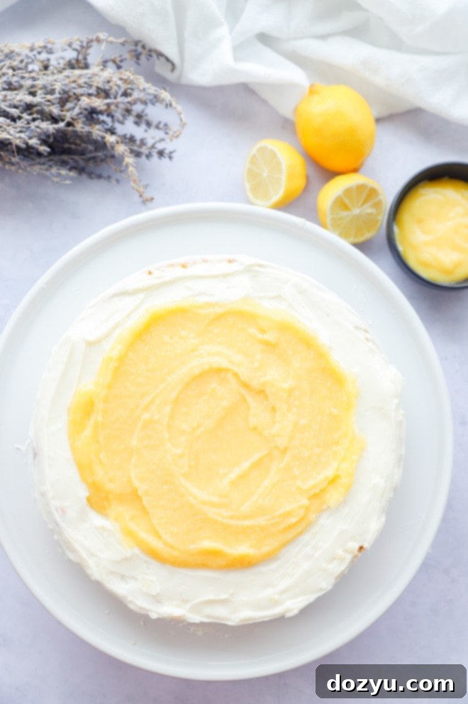 Assembling lemon lavender curd cake on a cake stand